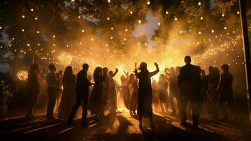 young adults dance in illuminated outdoor celebration photo