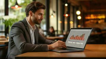 young businessman using laptop watching data chart photo