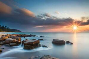 un hermosa puesta de sol terminado el Oceano con rocas y agua. generado por ai foto