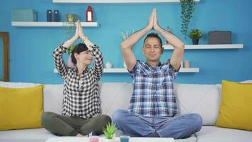 Married couple meditating at home. video