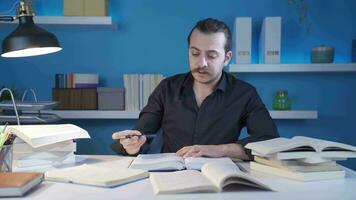 Researcher, journalist man working by looking at books. video