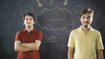 Young man writing Research on blackboard. video