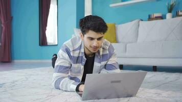 Young man chatting with his girlfriend on laptop and laughing excitedly. video