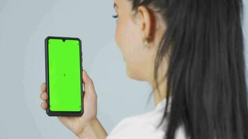 Happy woman looking at phone with Green Screen. video