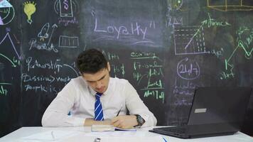 Businessman writes Loyalty on the board and smiles. video