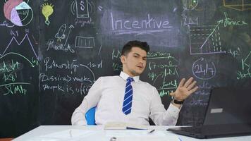 Businessman writes Incentive on the blackboard and speaks motivating. video