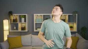 Man calming himself by doing breathing exercises. video