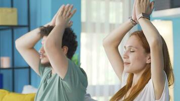 Married couple meditating at home. video