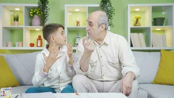 Grandfather congratulating the boy who came up with an idea. video