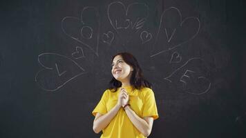 Young woman writing Love on blackboard. video