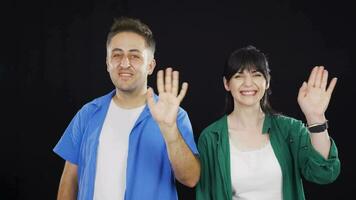 Couple waving at camera. video