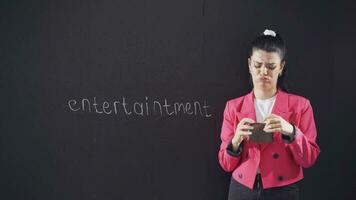 The woman with Fun on the chalkboard looks at her empty wallet. video