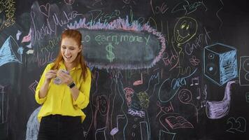 Young woman writing Make money on blackboard. video