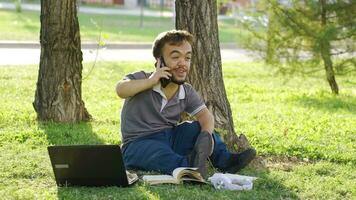 A college dwarf student rejoices when he receives good news on the phone. video