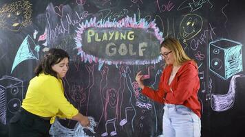 Young woman writing Playing Golf on blackboard. video