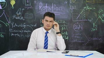 Businessman writes Rotation on the blackboard and is thoughtful. video