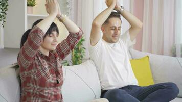 Married couple meditating at home. video