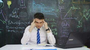 Businessman writes Brain power on the blackboard and shows head. video