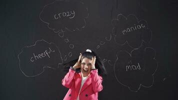 Woman writing lol on blackboard laughs looking at camera. video