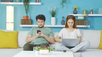 Married couple hanging out on laptop and phone. Technology use at home. video