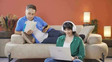 Married couple hanging out on laptop and phone. Technology use at home. video