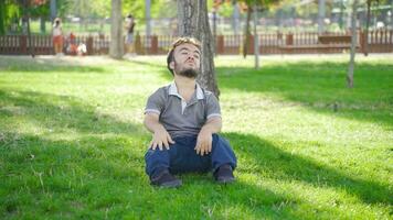 Dwarf young man with dizziness in the park. video