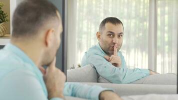 Psychologically disturbed schizophrenic man says shh. video