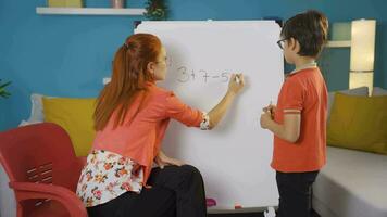 Teacher and boy student discussing a question. video