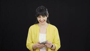 Woman counting money looking at camera. video