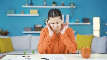 Young entrepreneur woman working in home office annoyed by loud noise. video