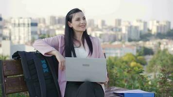 Successful and happy Businesswoman looking at laptop outdoors in the park. video