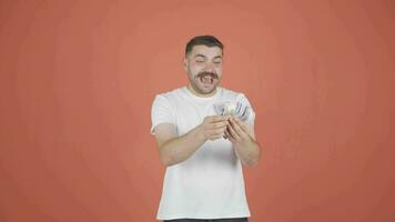 Man counting money looking at camera. video