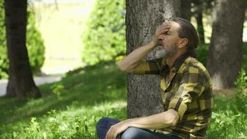 The man with the fever is sitting outside. video