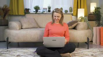 Woman working on laptop with happy expression. video