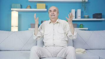 Depressed and sad old man talking to himself at home alone. video