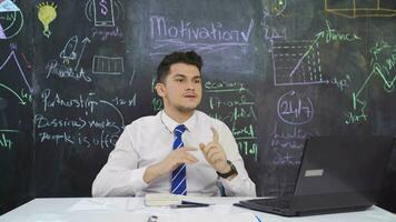 Businessman writes Motivation on the blackboard and motivates himself. video
