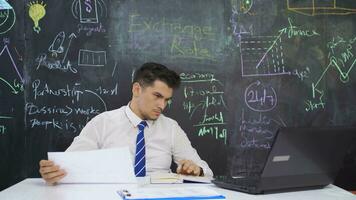 Businessman writes currency value on the board and is hopeful. video