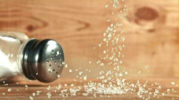 Salt falls on a wooden table. Filmed on a highspeed camera at 1000 fps. High quality FullHD footage video