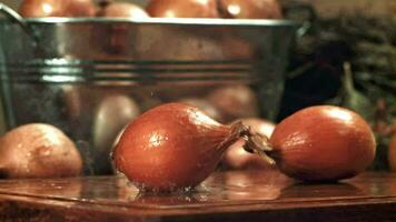 The onion falls onto the table with splashes. Filmed on a highspeed camera at 1000 fps. High quality FullHD footage video