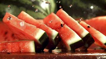 Drops of water fall on a pieces of watermelon. Filmed on a highspeed camera at 1000 fps. High quality FullHD footage video