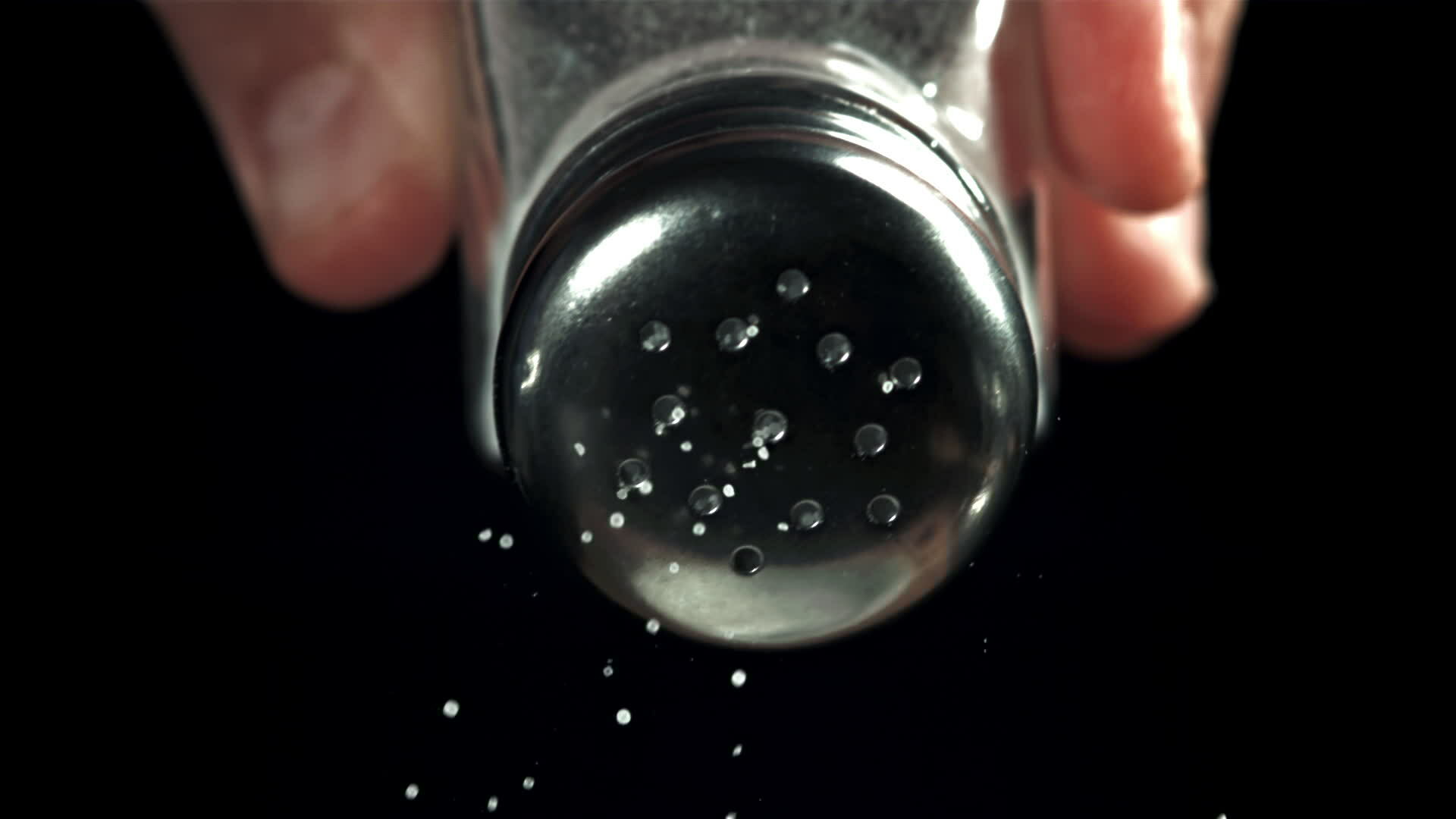 Salt flies out of the salt shaker. Filmed on a highspeed camera at 1000