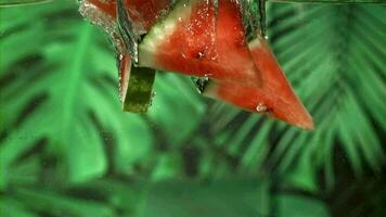 Watermelon slices fall under the water. Filmed on a highspeed camera at 1000 fps. High quality FullHD footage video