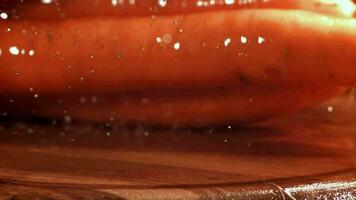 Carrots fall on a wet board. Macro shot. Filmed on a highspeed camera at 1000 fps. High quality FullHD footage video