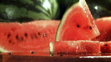 Watermelon slices fall on a wet table. Filmed on a highspeed camera at 1000 fps. High quality FullHD footage video