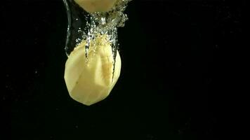 Peeled potatoes fall under water. Filmed on a highspeed camera at 1000 fps. High quality FullHD footage video