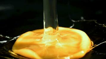 A raw egg falls onto a frying pan. Filmed on a highspeed camera at 1000 fps. High quality FullHD footage video