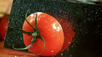 The knife cuts the tomato in half. Filmed on a highspeed camera at 1000 fps. High quality FullHD footage video