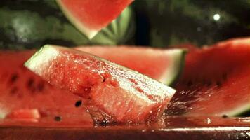 Watermelon slices fall on a wet table. Filmed on a highspeed camera at 1000 fps. High quality FullHD footage video