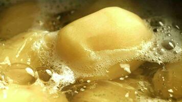 Peeled potatoes in boiling water. Filmed on a highspeed camera at 1000 fps. High quality FullHD footage video