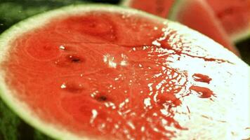 Drops of water fall on the cut of a watermelon. Filmed on a highspeed camera at 1000 fps. High quality FullHD footage video